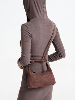 crossbody bag in chocolate brown featuring top handle and curved fit