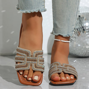 Brown open-toe sandals with dazzling rhinestone-adorned straps.