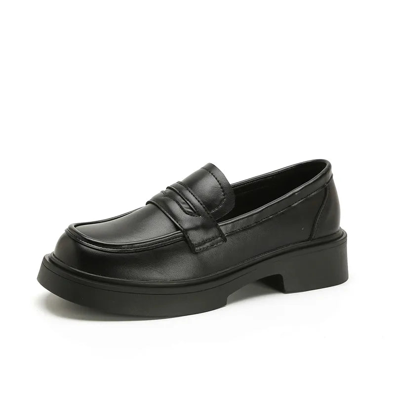 Black leather platform penny loafers with a thick sole.