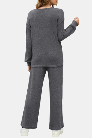 Dark gray ribbed knit lounge set with crew neck sweater and wide leg pants.