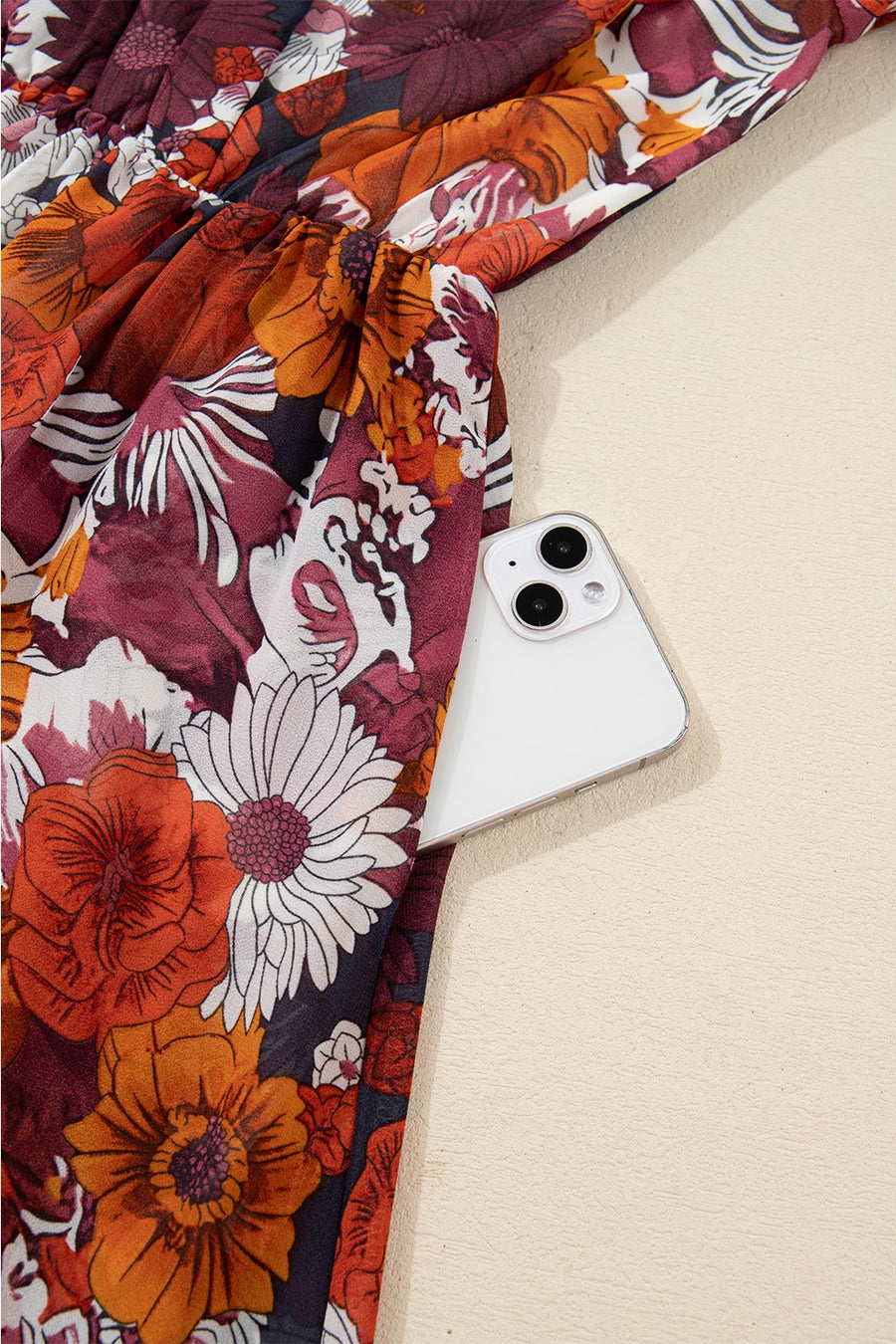 Floral wrap mini dress with puff sleeves and a cinched waist, featuring a bold floral print.