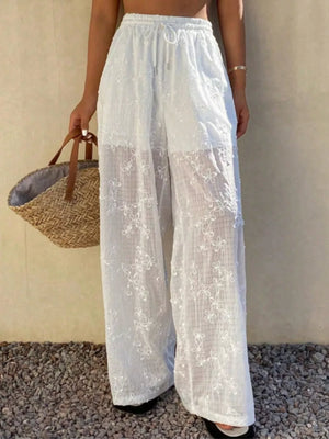 White wide-leg pants featuring embroidered and floral