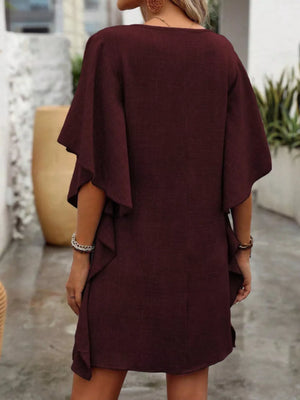 Wine red V-neck mini dress with flowy sleeves and ruffled hem.