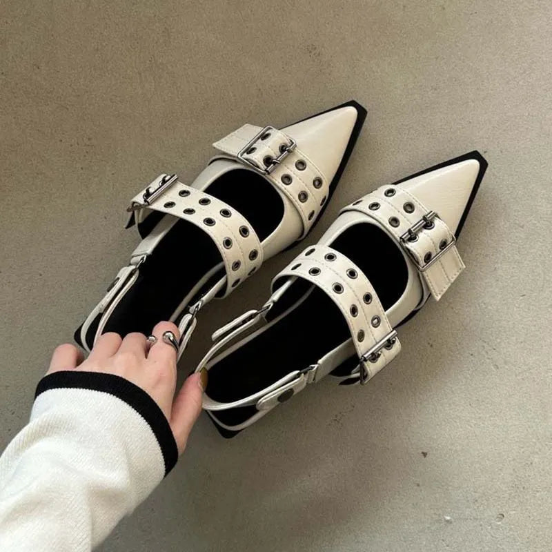 Beige studded pointed-toe slingback flats with double buckle straps.