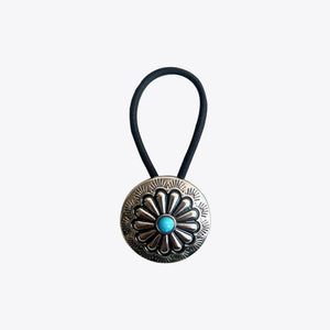 Southwestern hair tie with silver alloy medallion and turquoise center detail.