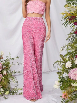 Pink sequin wide leg pants with a high waist and flowy silhouette.