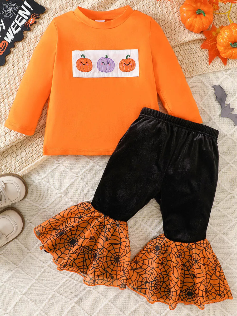 black pajama set featuring long sleeve and pumpkin embroidery, spiderweb print