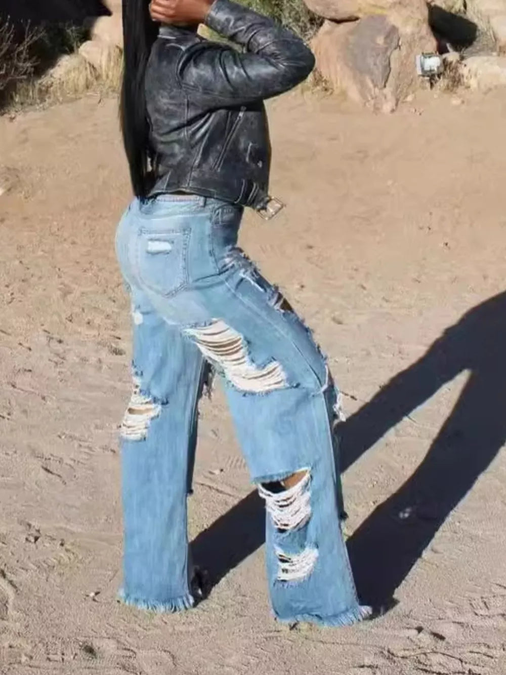 Distressed wide-leg maternity jeans in light wash denim with frayed hems and large ripped details.