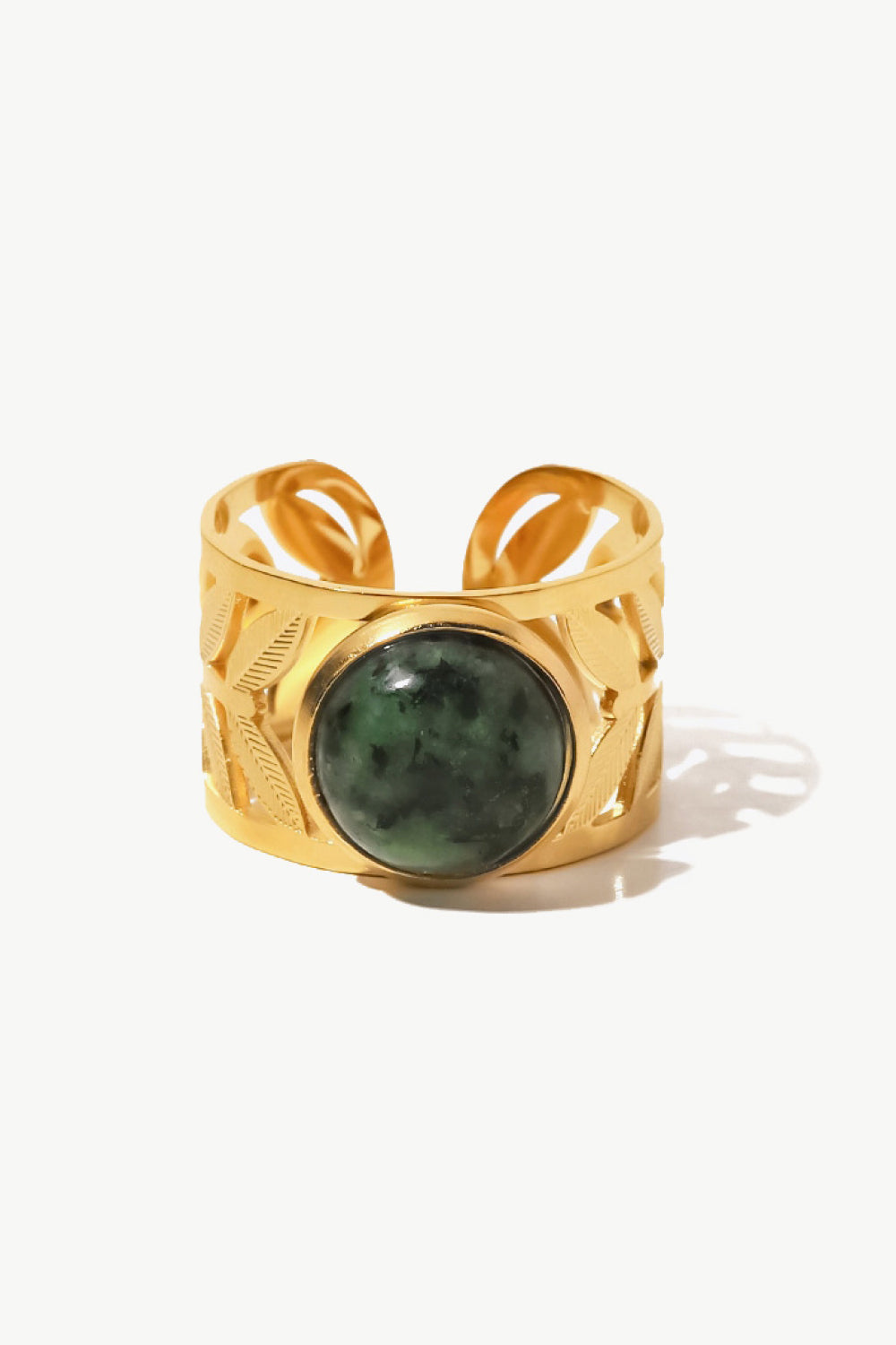 Gold ring with leaf cutouts and a green malachite stone