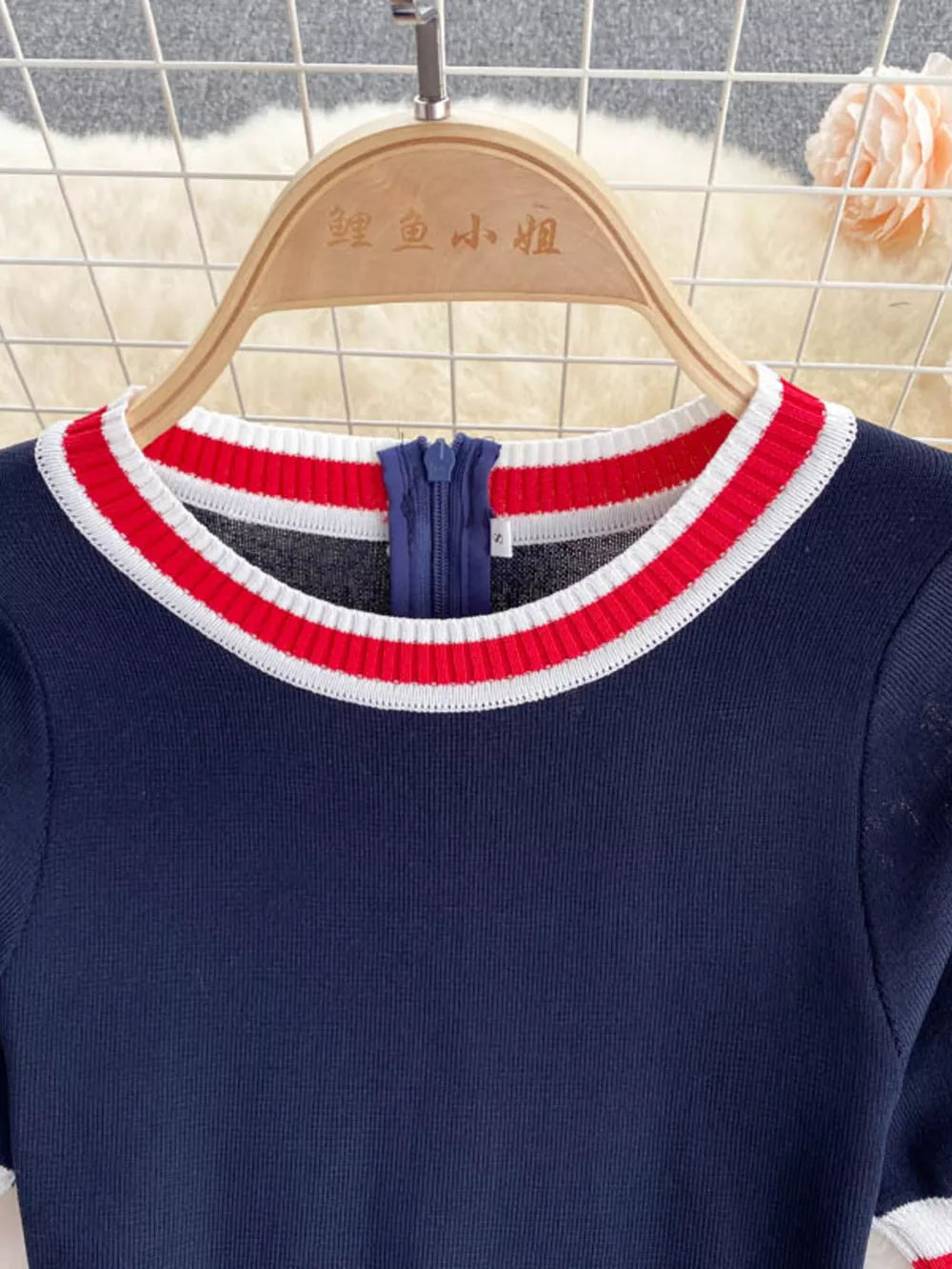 Navy knit dress with red and white striped collar and zipper detail