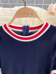 Navy knit dress with red and white striped collar and zipper detail