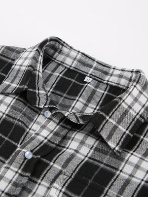 Oversized black and white plaid button-up shirt with collar and light blue buttons.