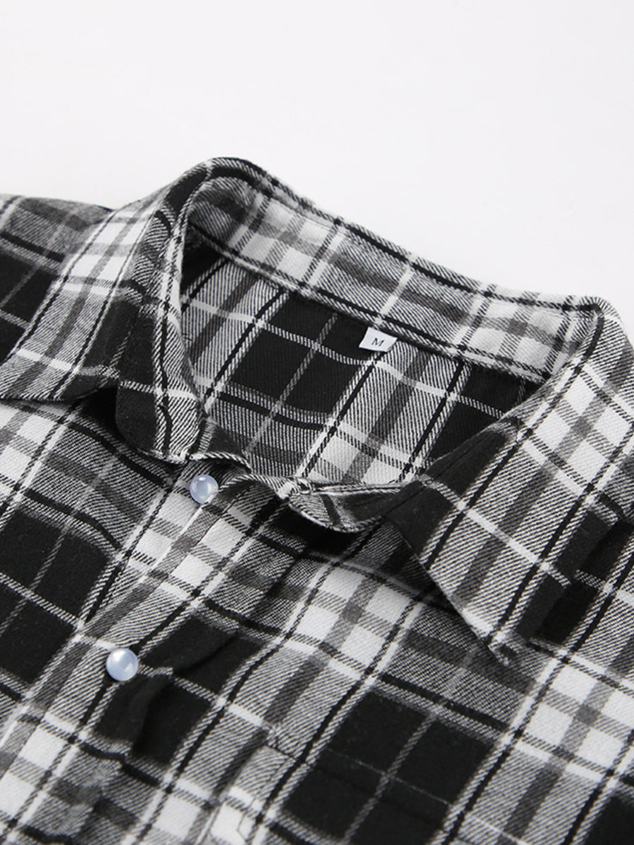 Oversized black and white plaid button-up shirt with collar and light blue buttons.