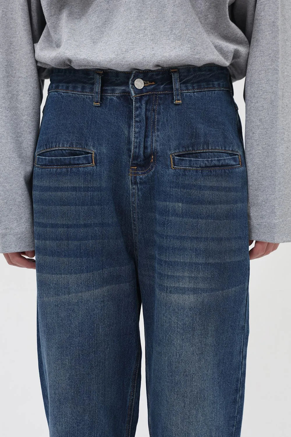 Light blue denim cargo pants with front flap pockets and a relaxed fit.