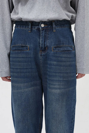 Light blue denim cargo pants with front flap pockets and a relaxed fit.