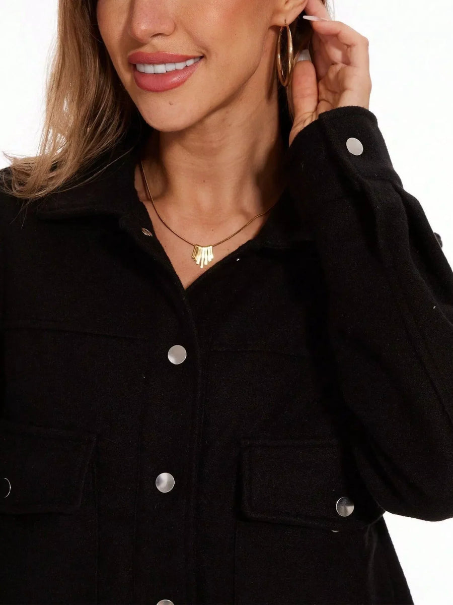 Black trucker jacket with snap buttons and chest pockets.