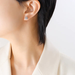 Silver rosebud stud earrings with intricate petal detail.