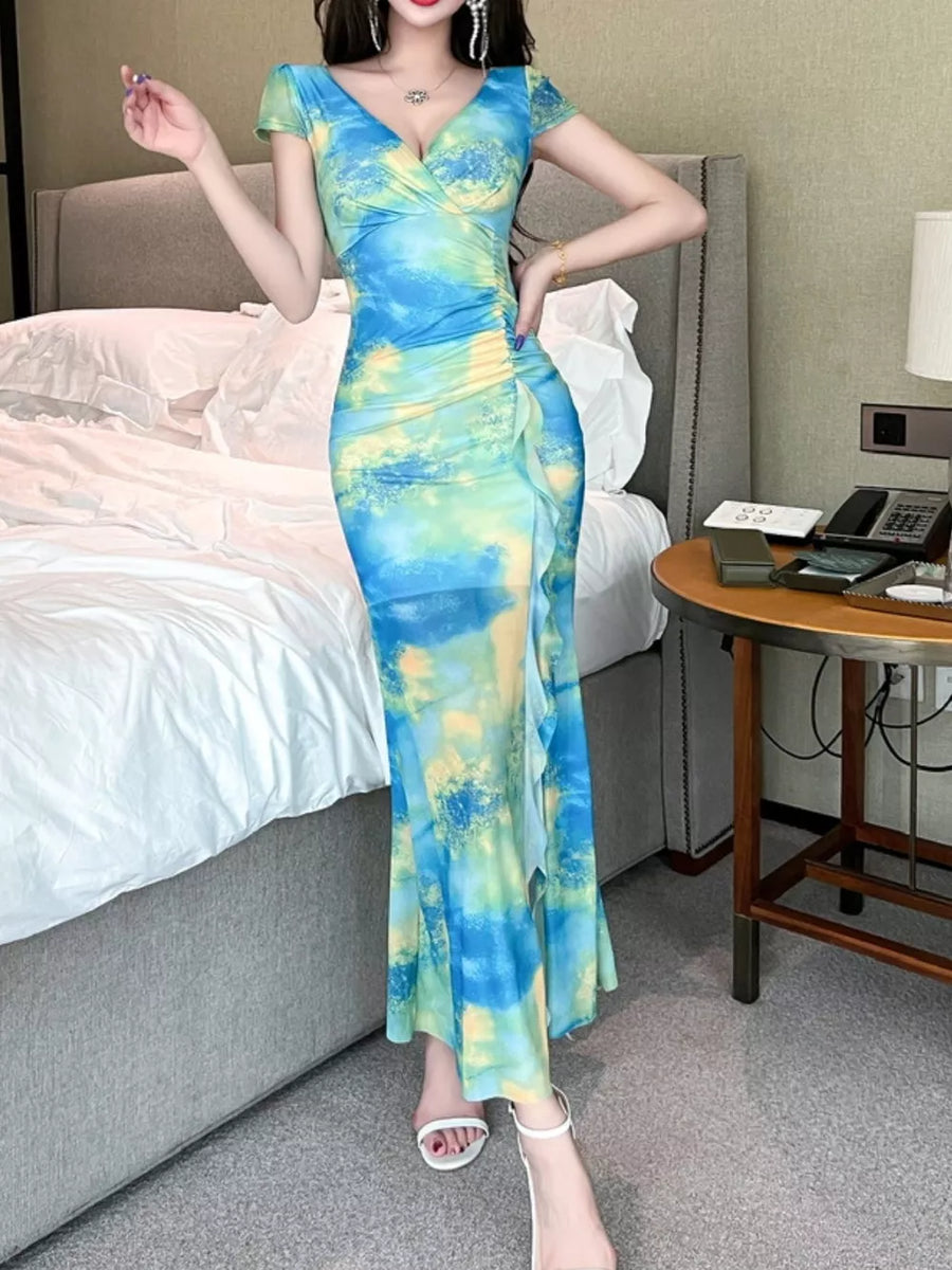 Surplice ruffle maxi dress in blue and green tie-dye with ruched side detail.