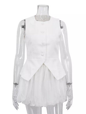White sleeveless peplum vest with button front and layered tulle skirt.