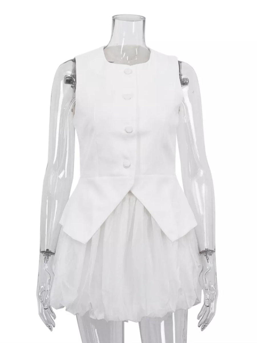 White sleeveless peplum vest with button front and layered tulle skirt.