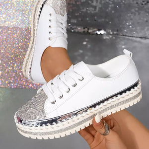 White casual sneakers with glittering rhinestone toe and chunky sole.