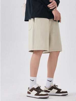 Beige chino shorts with drawstring and relaxed fit, shown on a man.