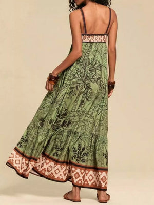 Moss maternity maxi swim dress with tropical print, tiered skirt, and patterned border.