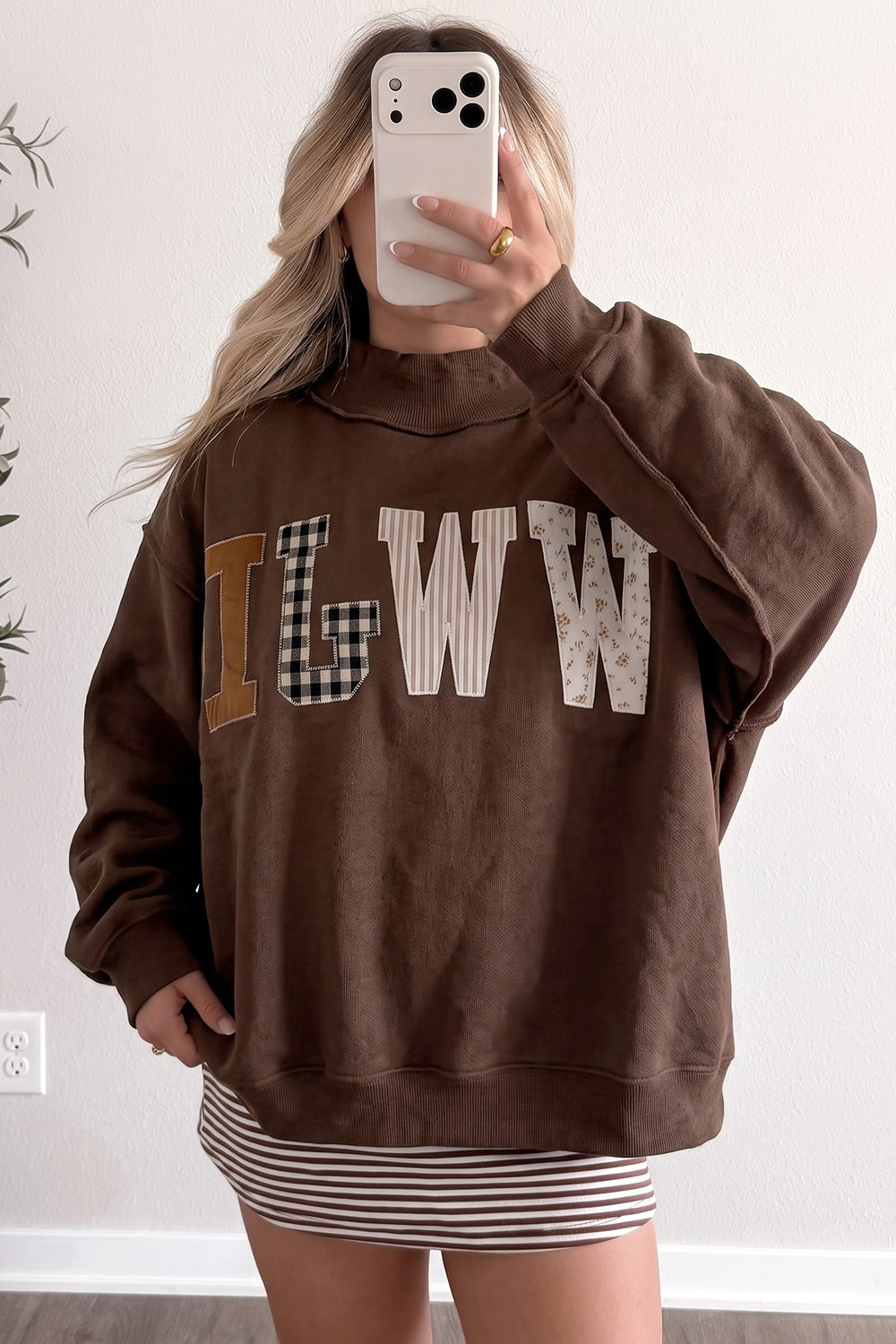 dark brown sweatshirt with mixed pattern, graphic, gingham, striped, ditsy floral and mock neck