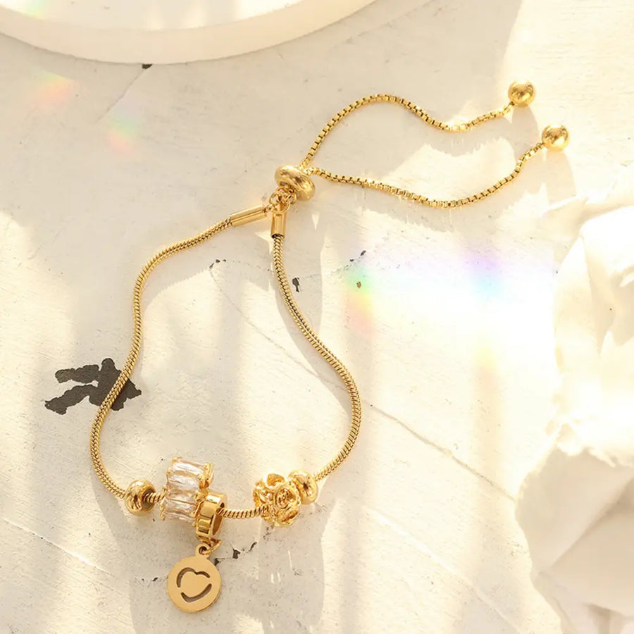 Gold charm slider bracelet with smiley face and crystal charms, 18K gold-plated