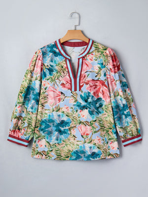 Women's cotton V-neck blouse with a bold floral print and contrast trim details.