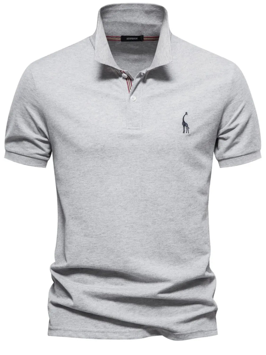 Gray piqué polo shirt with giraffe embroidery and striped collar detail.