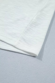 White polyester t-shirt with subtle heathered texture and ruffled detail.