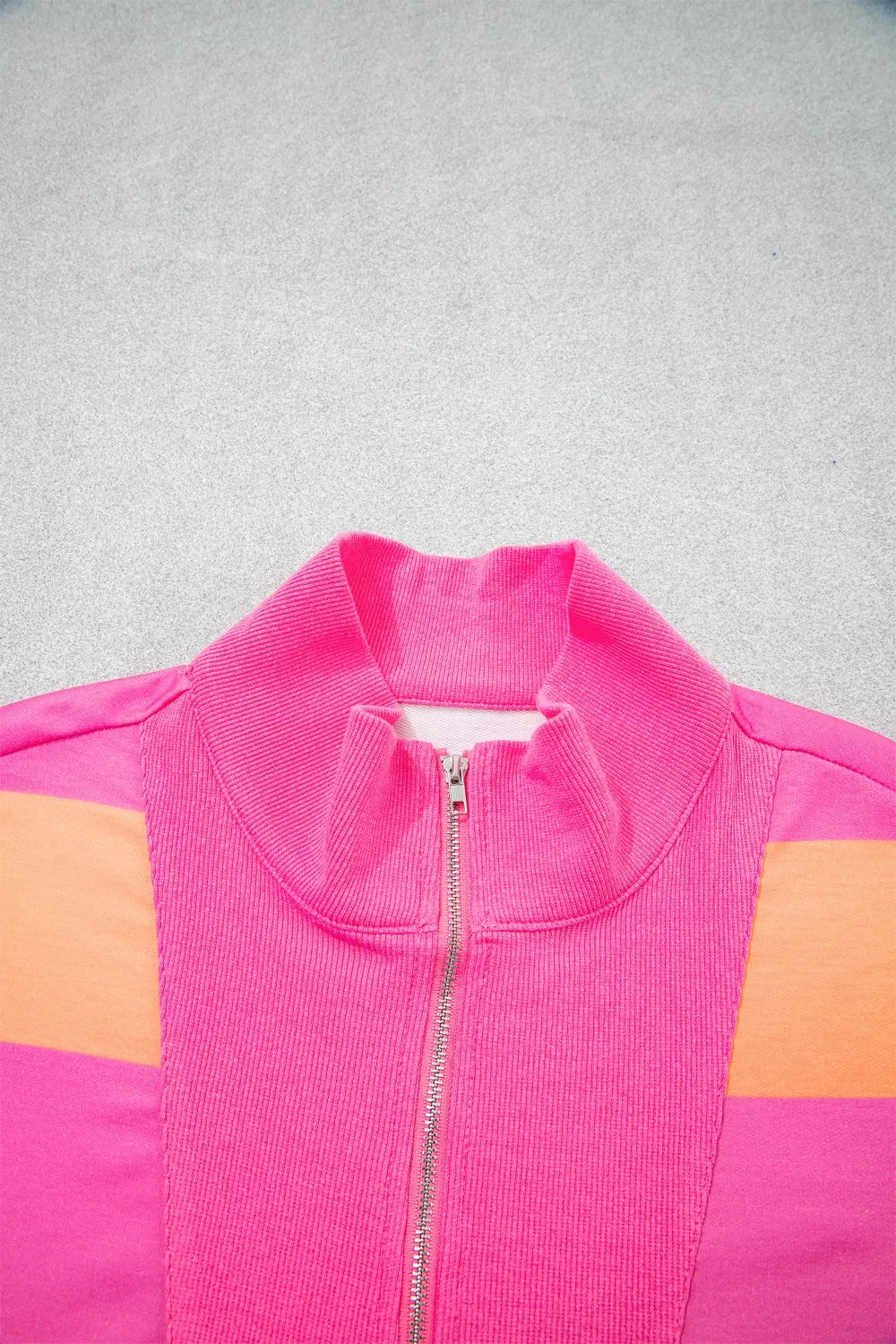 Vibrant striped two-piece set jacket with color block detail and zip-up collar.