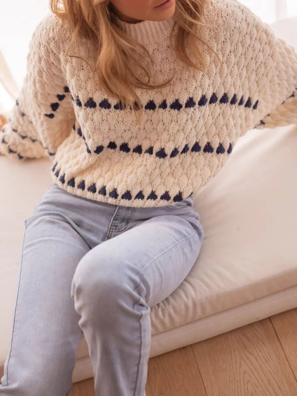 Cream oversized knit sweater with navy geometric stripes, crew neck, long sleeves.