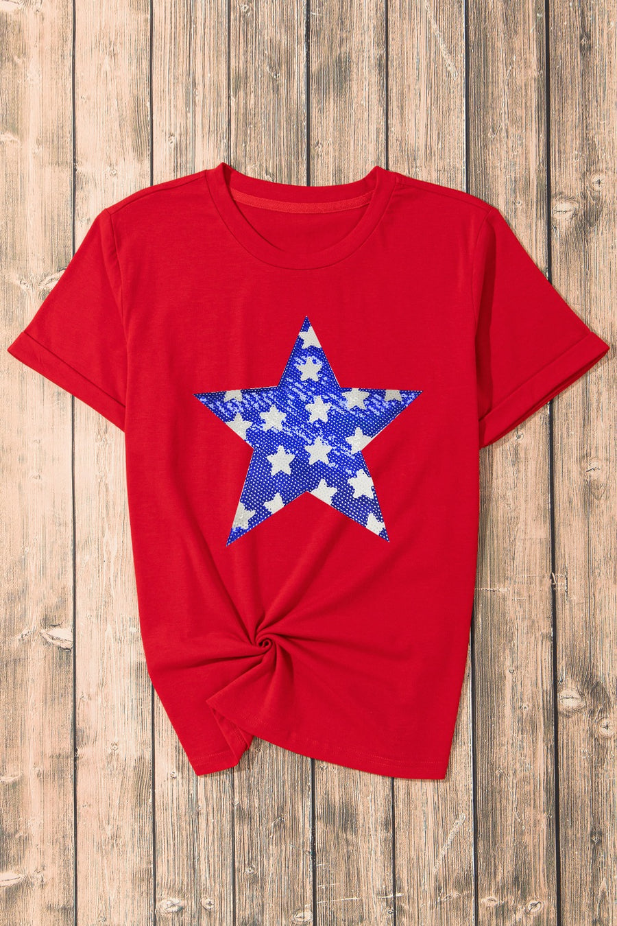 Red cotton blend t-shirt with a blue and white star graphic and a knotted hem.