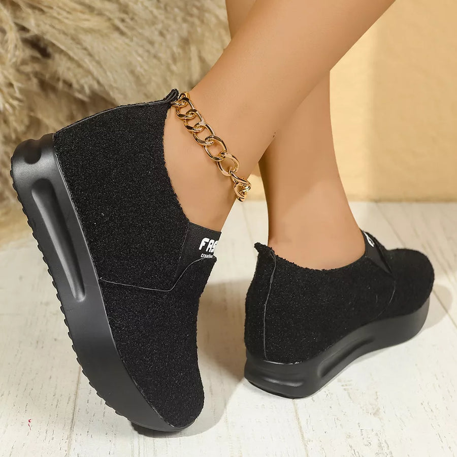 Black textured round toe platform sneakers with a gold chain anklet.