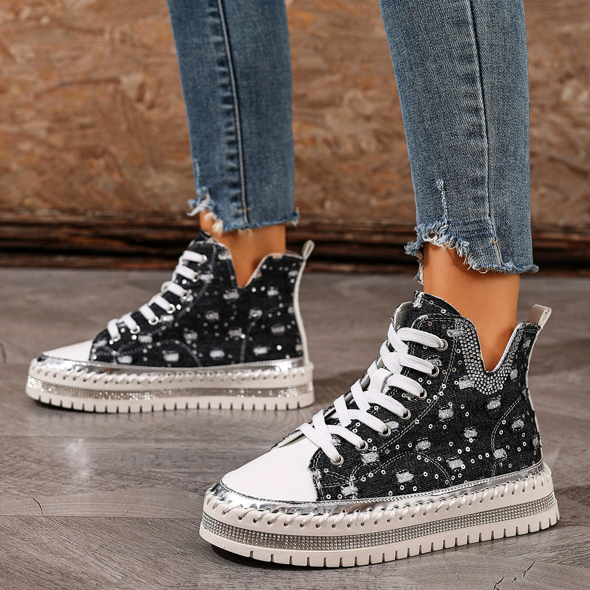 Black canvas high-top sneakers with white laces and a sequined platform sole.