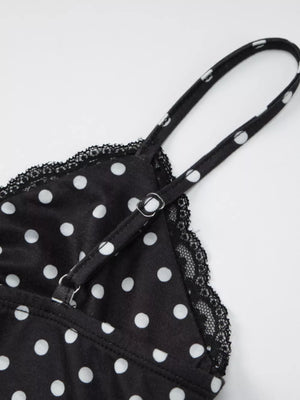 Black polka dot cami with white dots, lace trim, and adjustable straps.