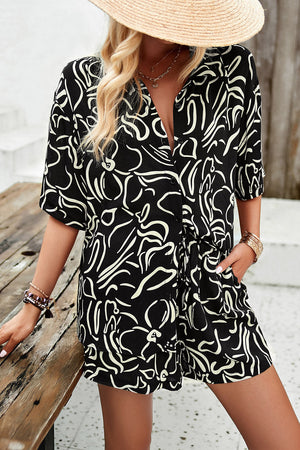 Black abstract print resort shirt with button-down front and short sleeves.