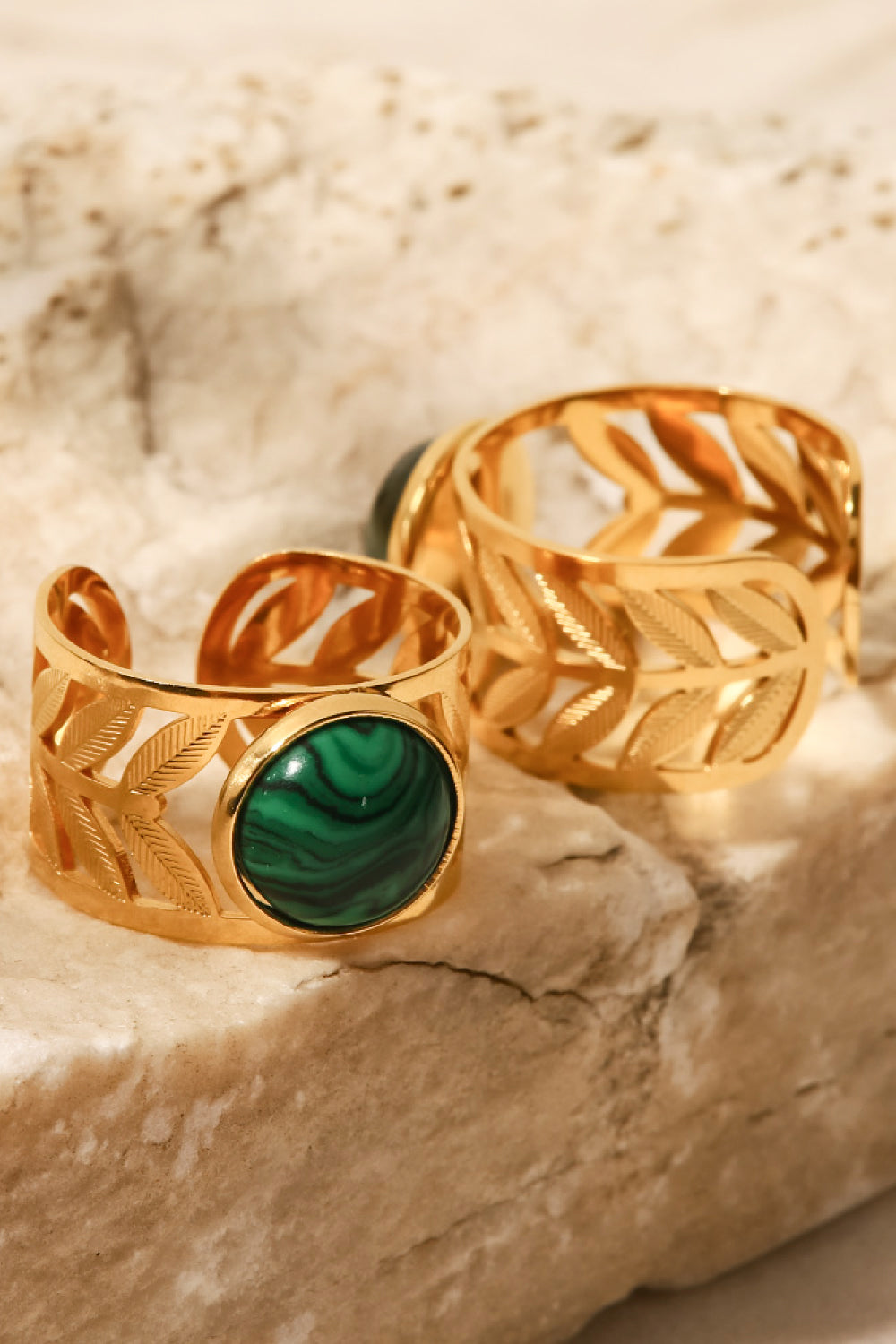 Leaf-cut gold ring with malachite stone and matching band ring.