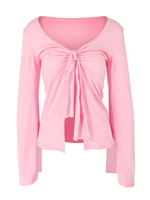 Pink long sleeve blouse with tie-front detail and V-neck.