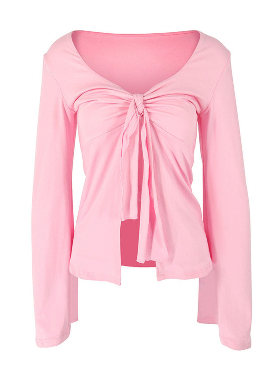 Pink long sleeve blouse with tie-front detail and V-neck.