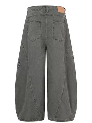 Grey wide-leg cargo pants with large pockets and contemporary stitching detail.