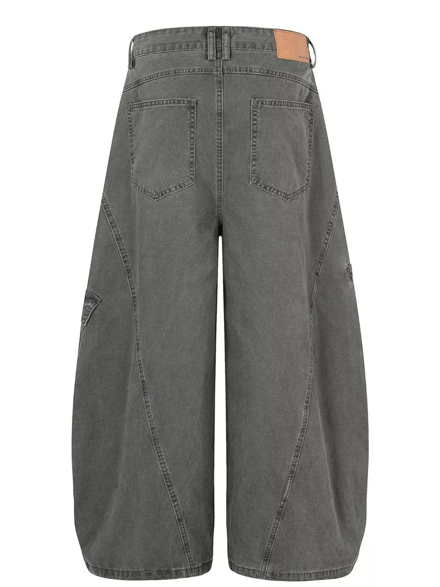 Grey wide-leg cargo pants with large pockets and contemporary stitching detail.