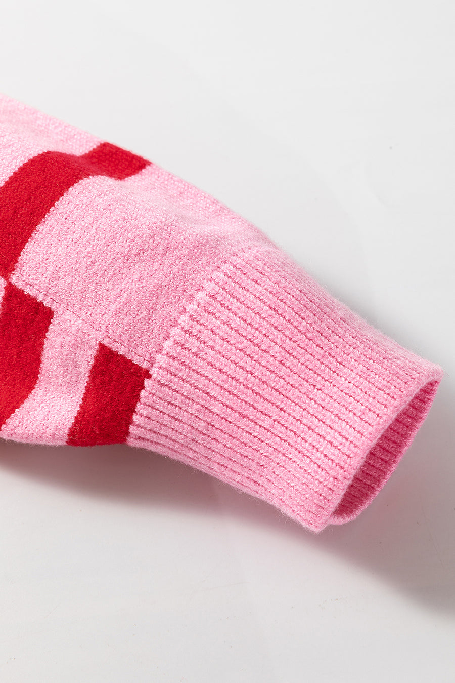 Colorblock stripe knit sweater in hot pink with red stripes and balloon sleeves.