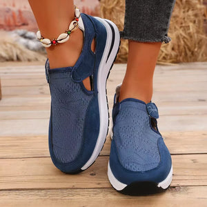 Blue breathable cutout slip-on sneakers with mesh and suede details.
