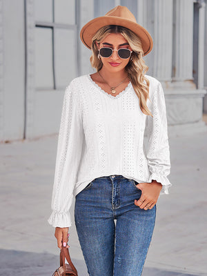 White eyelet blouse with lace trim neckline and ruffle cuffs.