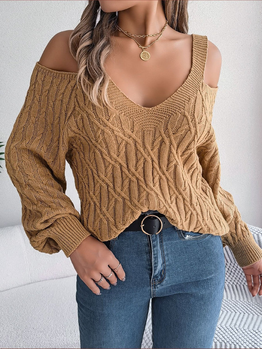 Knit cold shoulder sweater in taupe with cable knit pattern and V-neckline.
