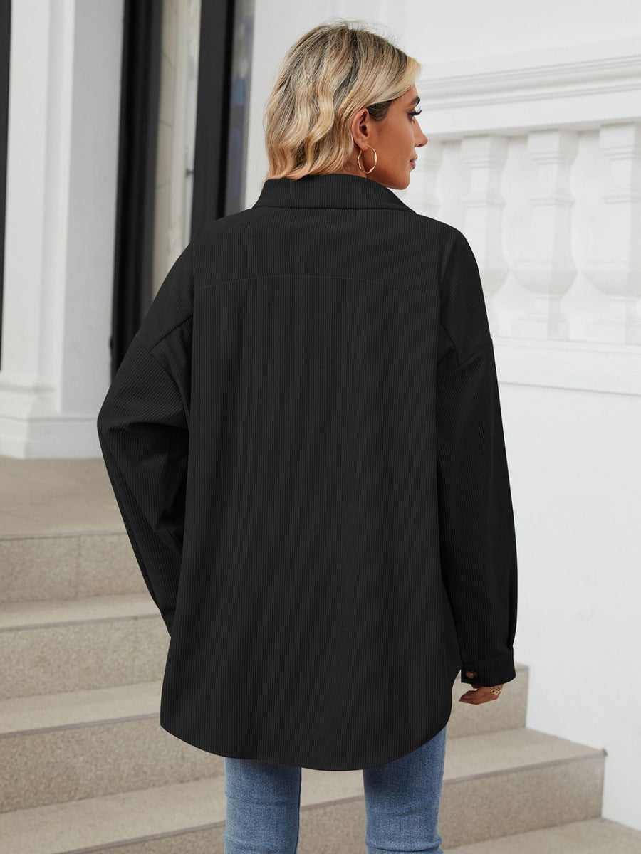 Black oversized corduroy shirt jacket with buttoned cuffs and a collar.