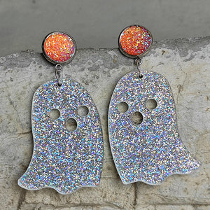 Ghostly iridescent acrylic dangle earrings with glittery orange tops.